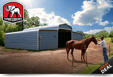 Metal horse barn in a county style with two fully enclosed lean-to's.